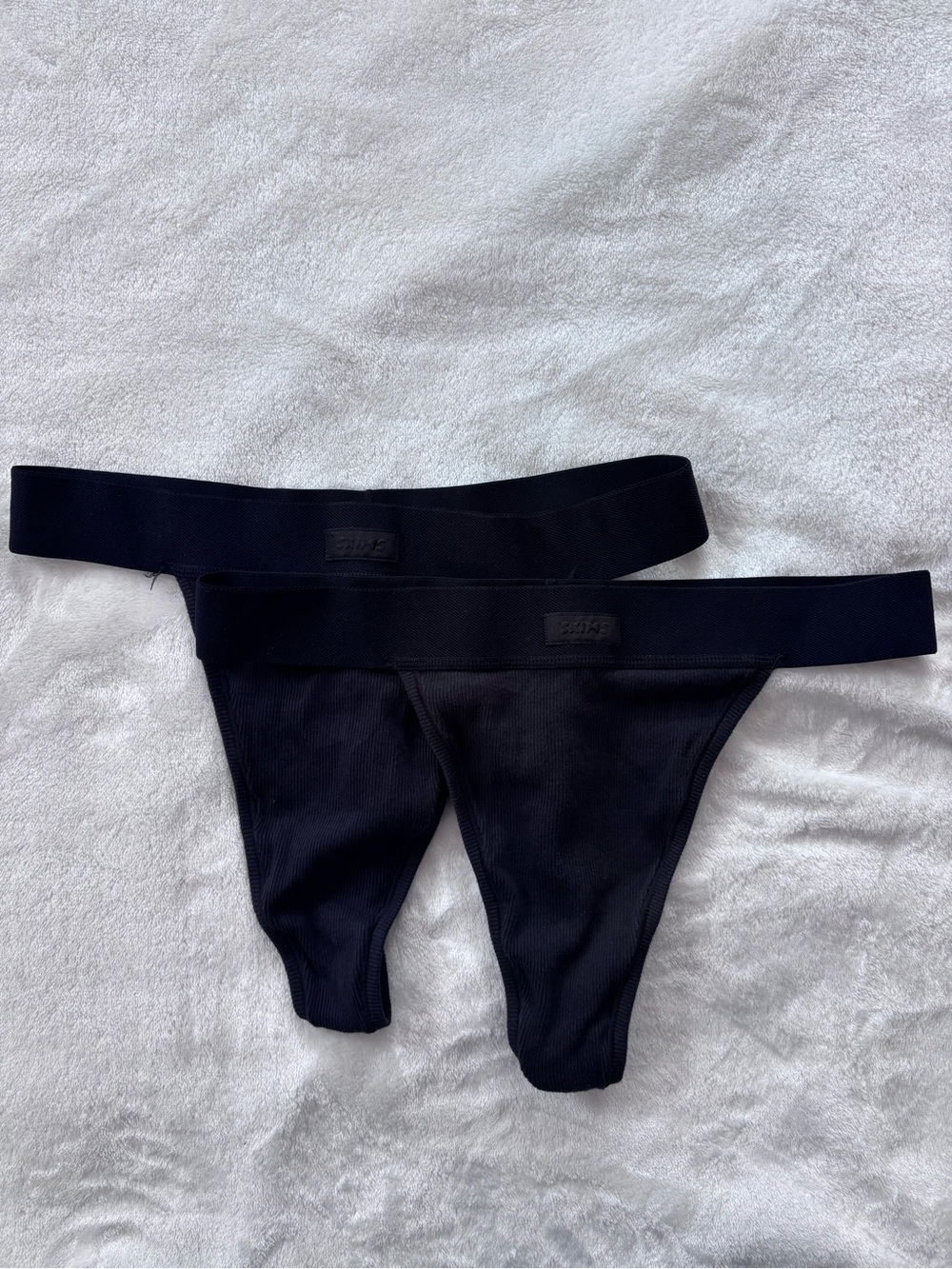 Three SKIMS cotton ribbed thongs